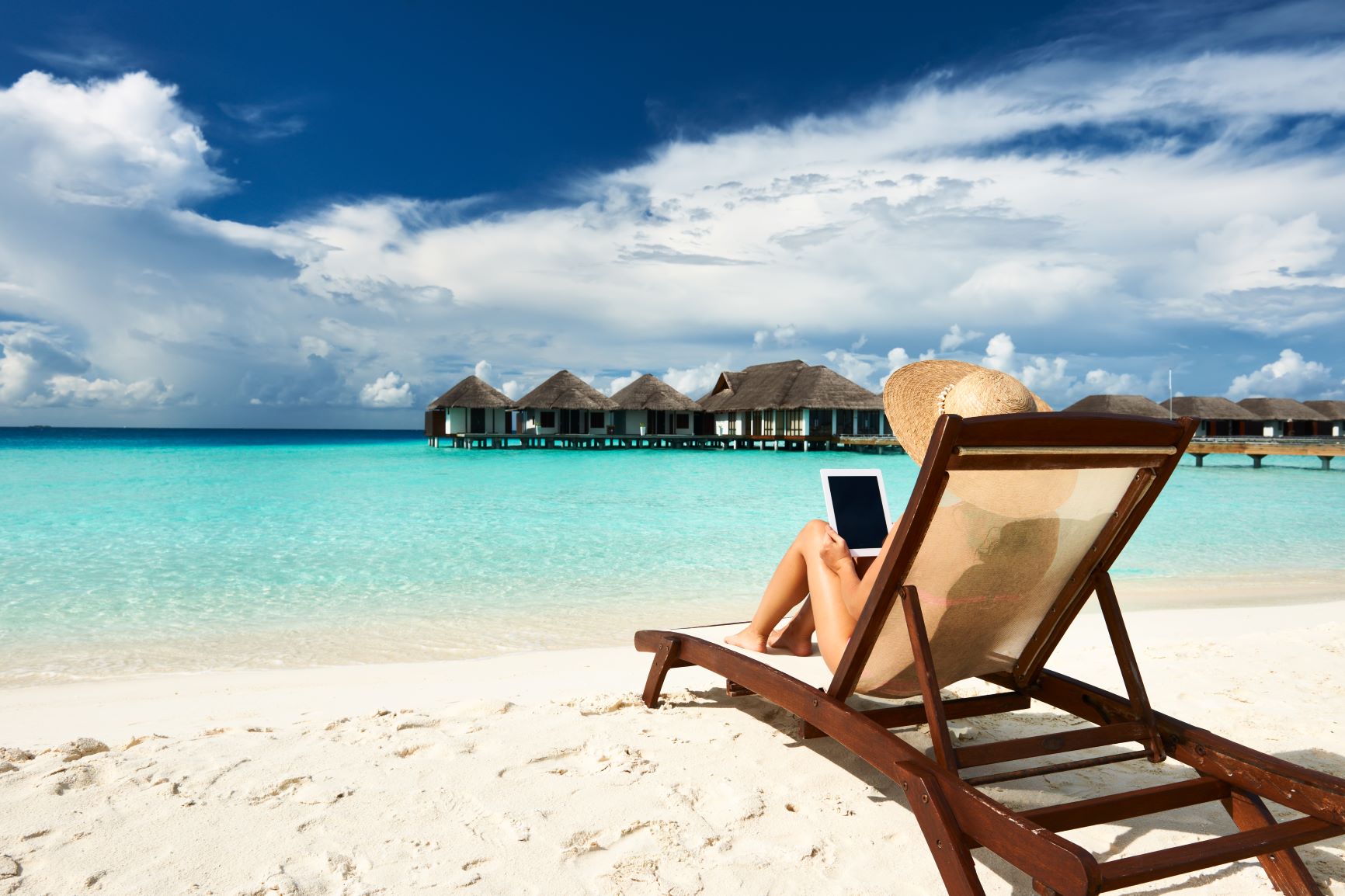 woman with tablet on beach